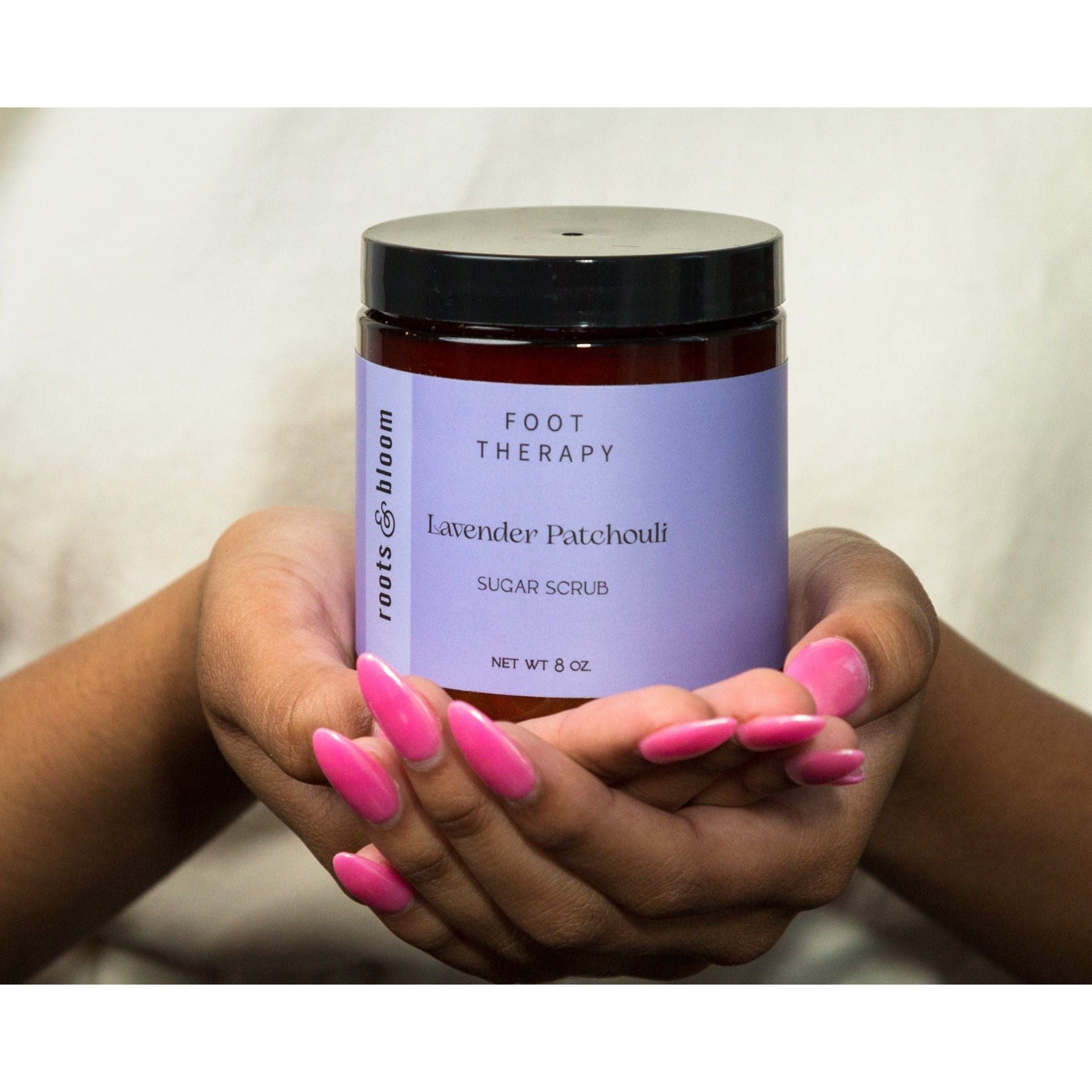 Exfoliating Sugar Scrub Held in Hands- Lavender Patchouli Scent by Roots and Bloom Skin Care